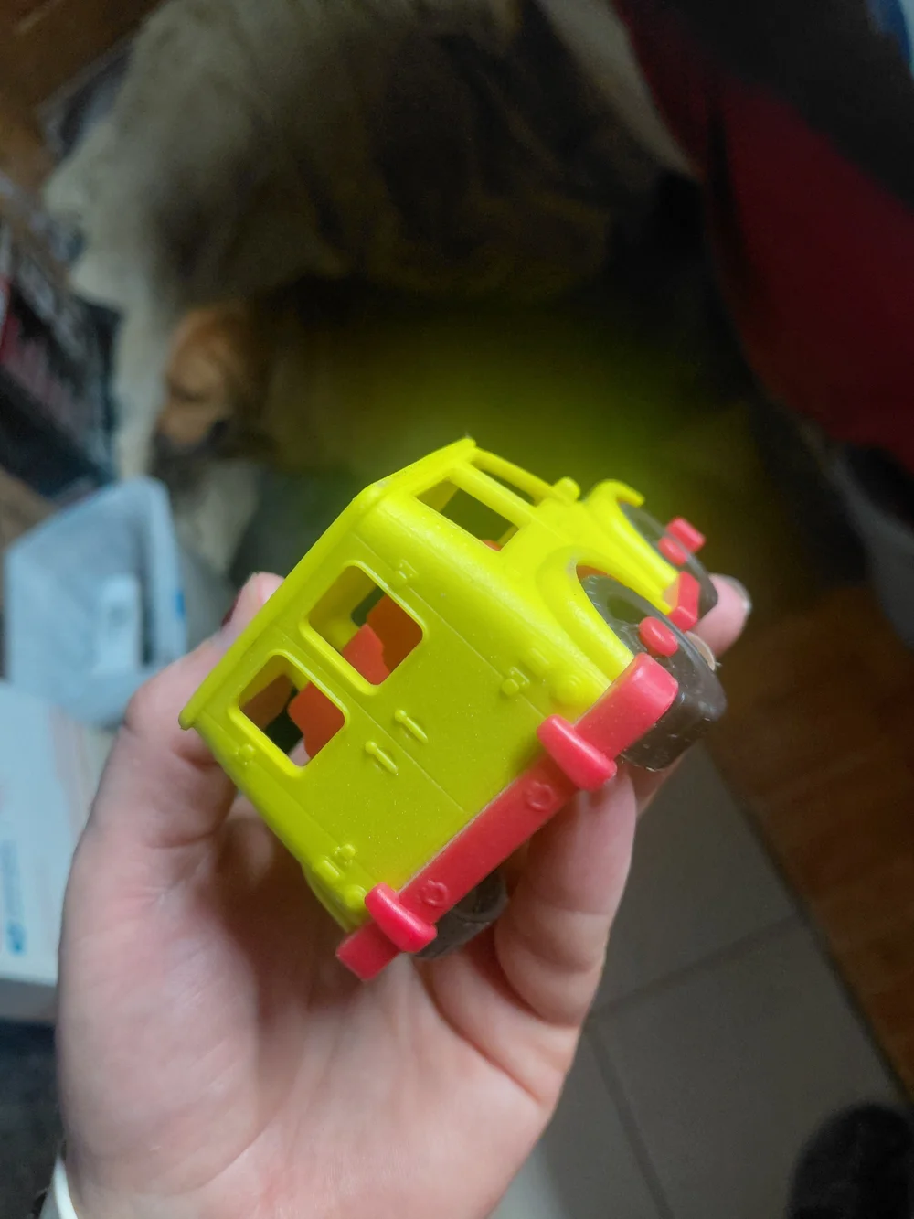 yellow toy vehicle is a B. toys Happy Cruisers Mini 4x4, featuring chunky wheels